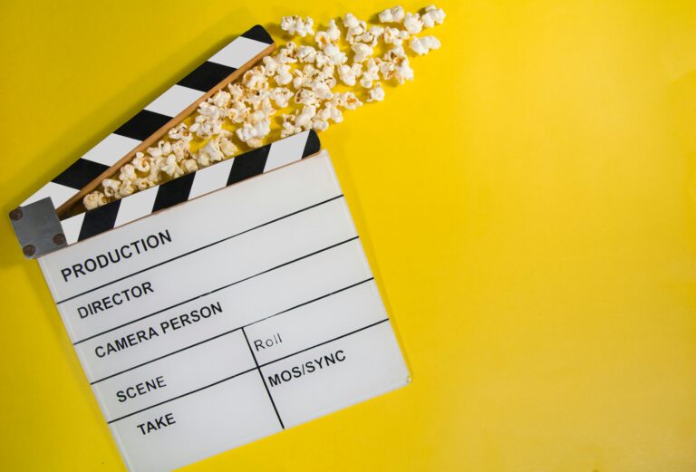 Movie clapperboard and popcorn, illustrative cinema image